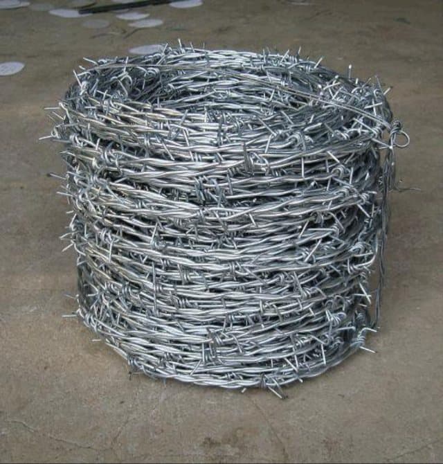 Roll of galvanised barbed wire
