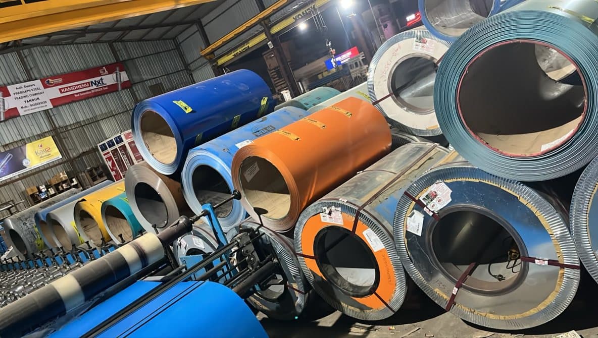 Blue and orange colour coated steel coils under the overhead crane