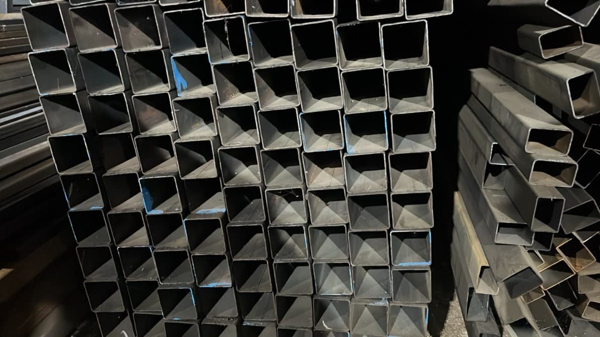 Stacked MS square hollow sections viewed end-on in the stockyard